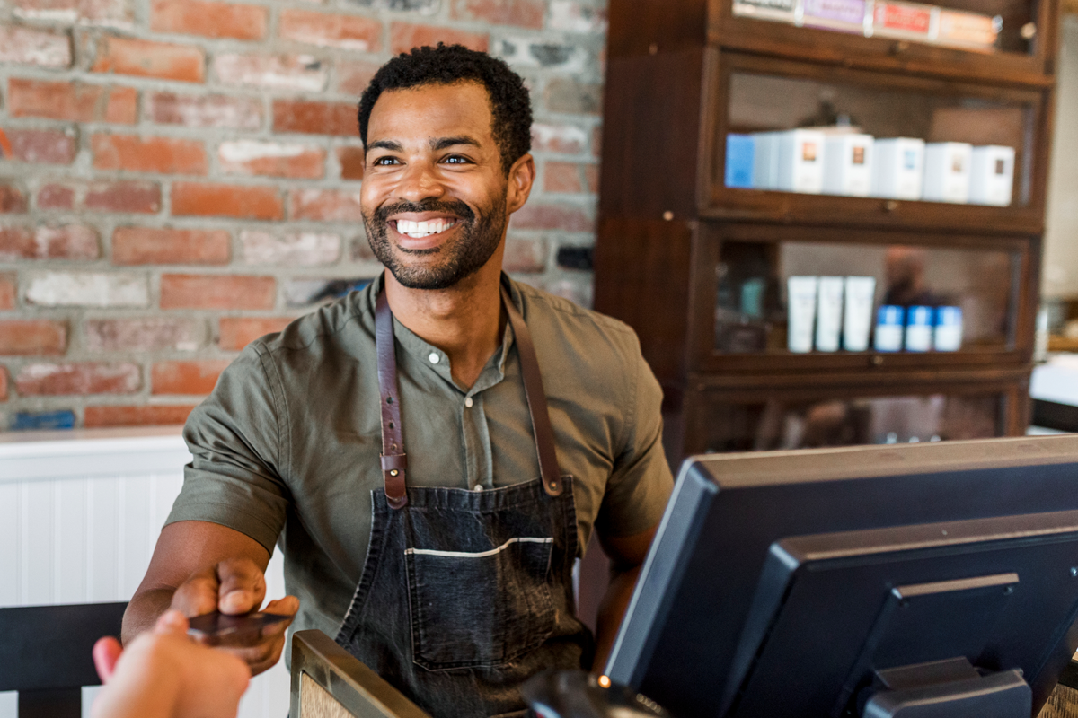 Man paying at the barbershop with credit card
