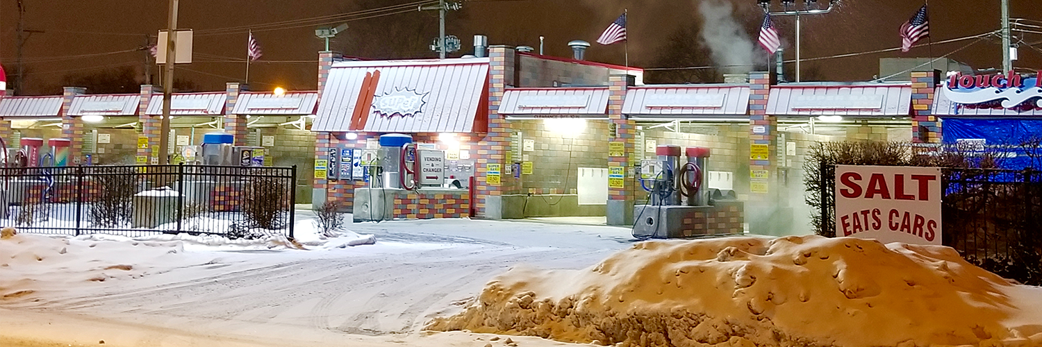 Self-serve car wash in snowy winter conditions showcasing the need for weatherproof unattended payment solutions from MONEXgroup