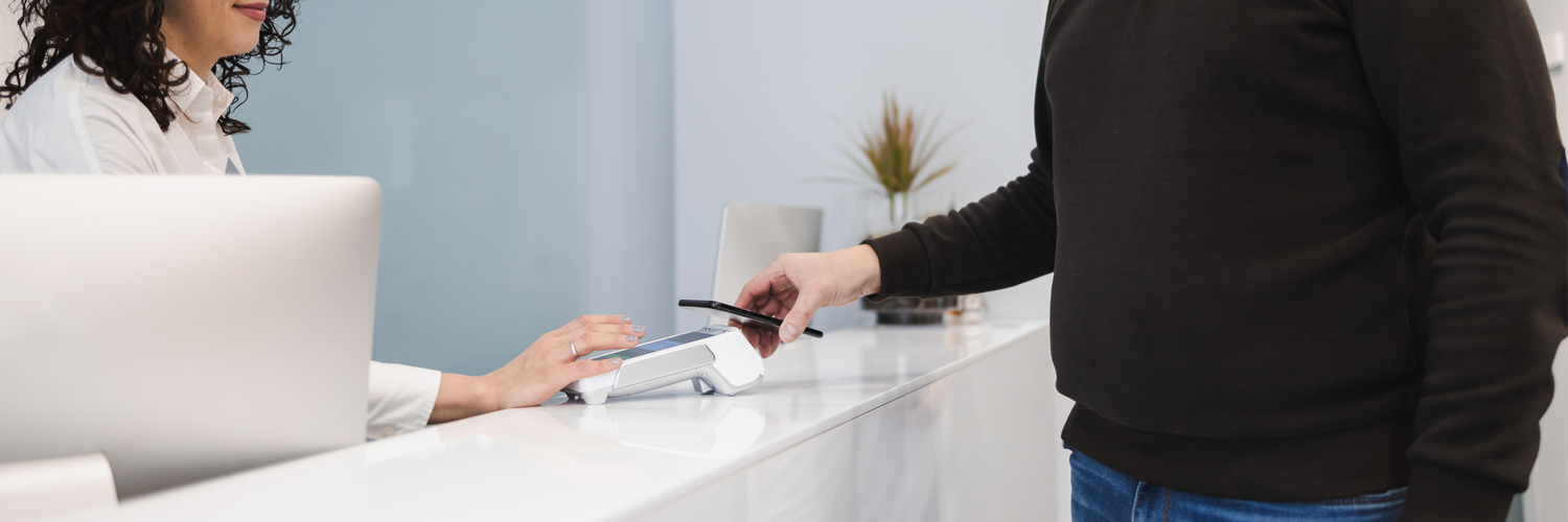 Client making a card payment at a counter using a modern POS system that supports accurate transaction tracking and reporting.