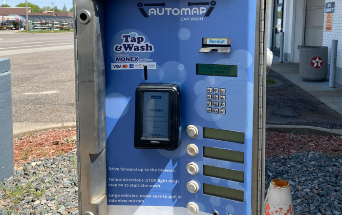 Car wash payment kiosk with MONEXgroup PayPro terminal, contactless tap payment, keypad selection, and receipt printer