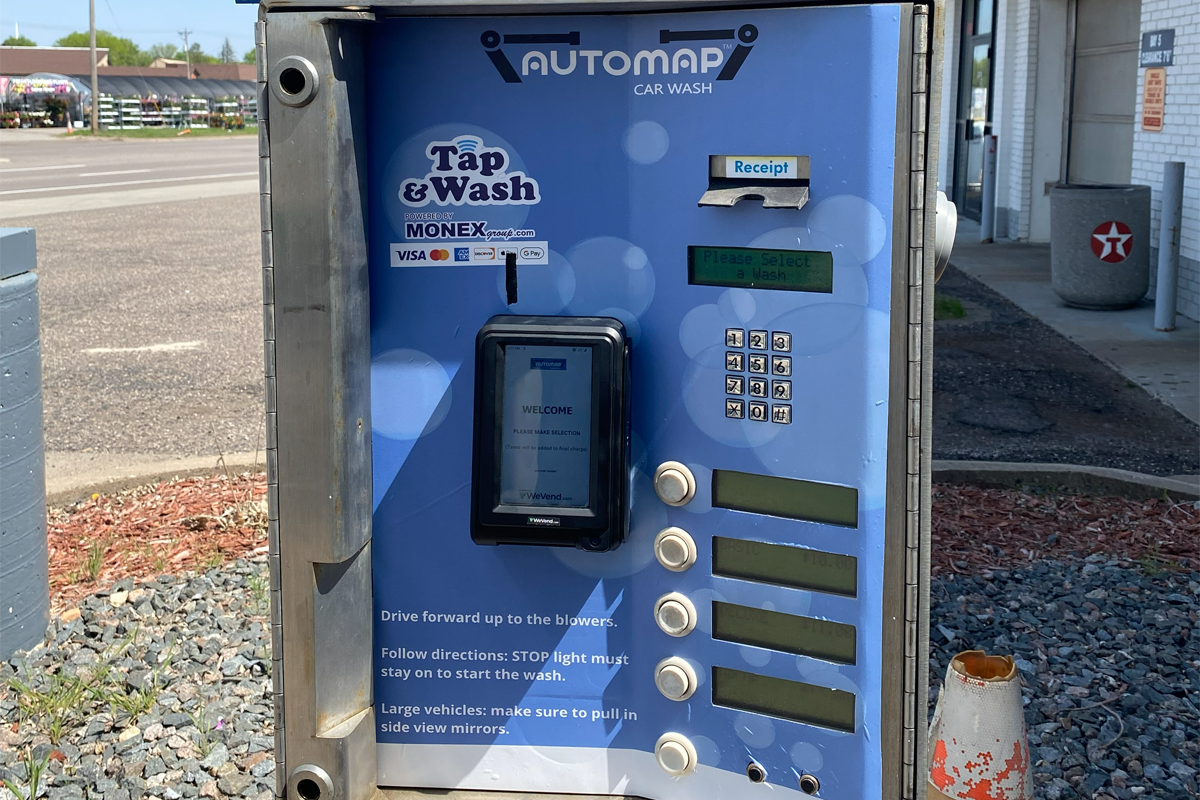 Car wash payment kiosk with MONEXgroup PayPro terminal, contactless tap payment, keypad selection, and receipt printer