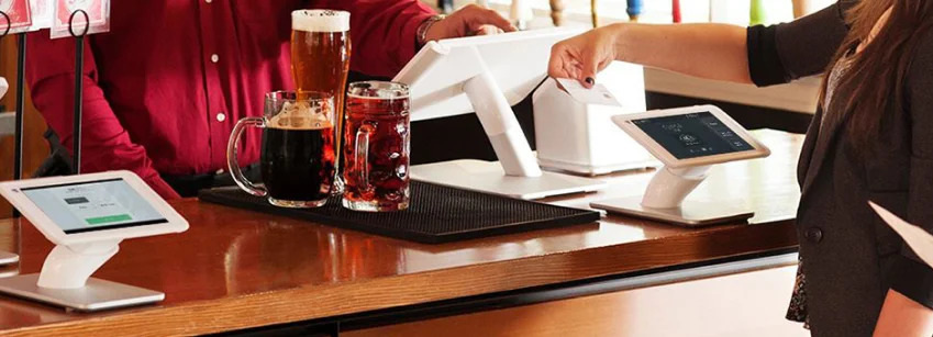 Restaurant bar payment processing with Clover POS terminal and customer-facing screen by MONEXgroup