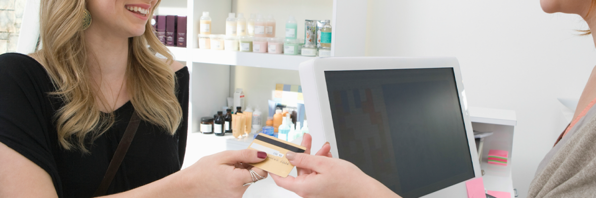 Woman paying with credit card at the salon